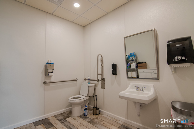 113 School Street Killingly, CT 06239 - Photo 12 of 33 a bathroom with a toilet a sink and mirror