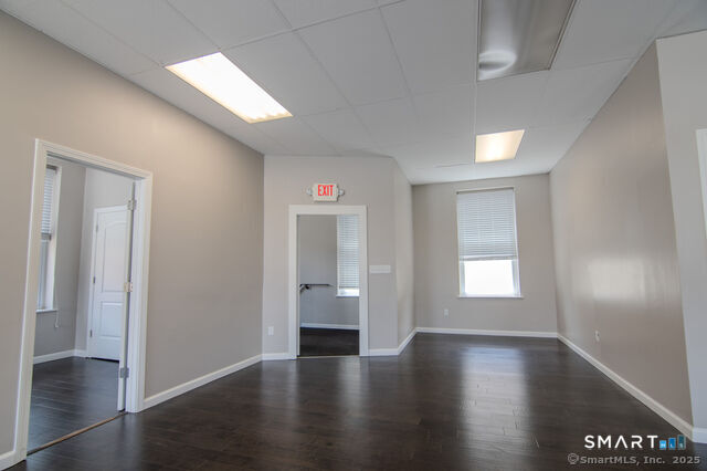 113 School Street Killingly, CT 06239 - Photo 14 of 33 an empty room with wooden floor and windows