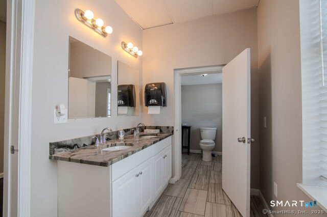 113 School Street Killingly, CT 06239 - Photo 15 of 33 a bathroom with a double vanity sink and a mirror