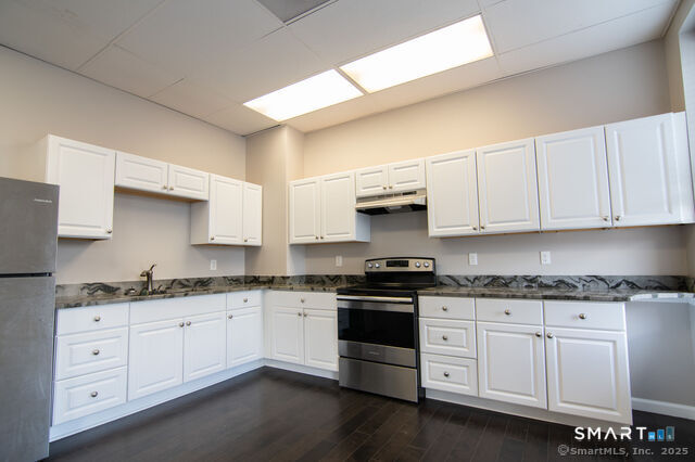 113 School Street Killingly, CT 06239 - Photo 17 of 33 a kitchen with granite countertop white cabinets and white appliances