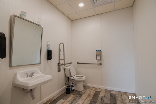 113 School Street Killingly, CT 06239 - Photo 10 of 33 a bathroom with a toilet sink and mirror