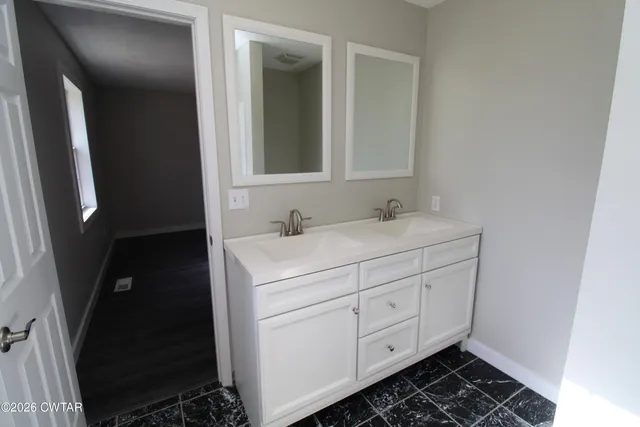 a bathroom with a sink and a mirror