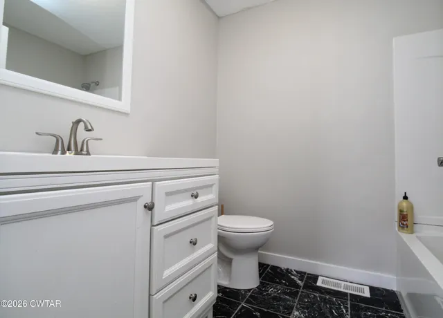 a bathroom with a sink toilet and a mirror