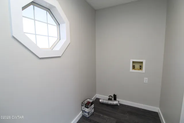 a view of a yard with wooden fence