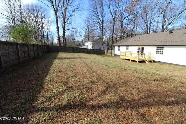a backyard of a house with oven and a yard