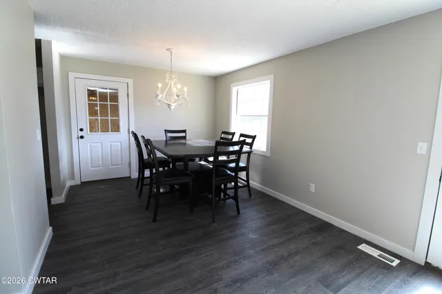 a view of a dining room with furniture and window