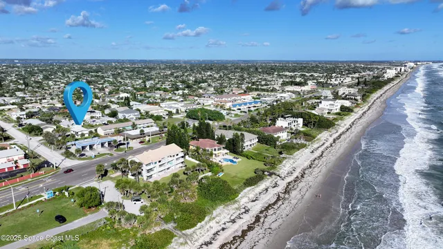 an aerial view of residential houses with outdoor space and street view