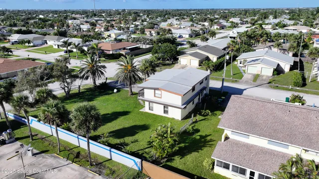 an aerial view of multiple houses with yard