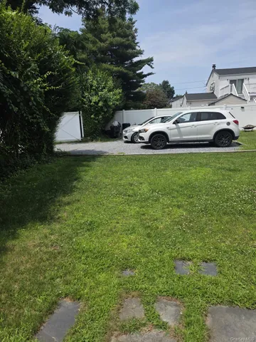 a view of yard with car parked