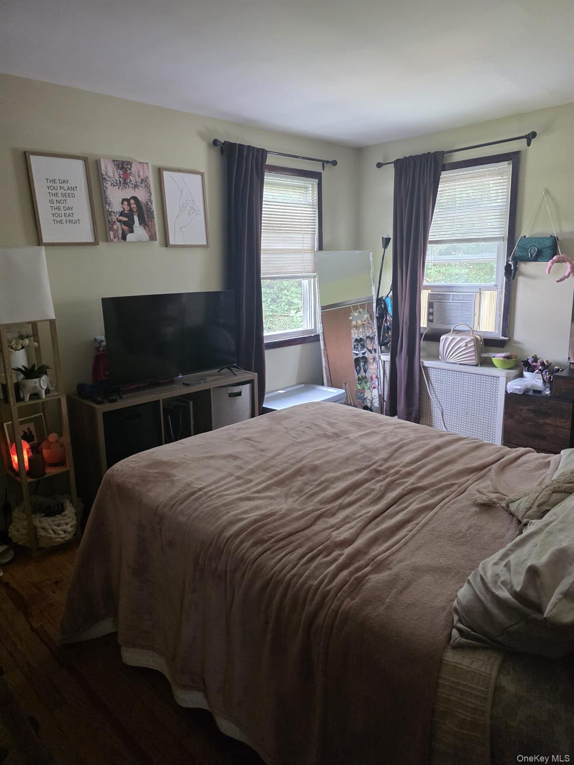 23 Seaman Neck Road Dix Hills, NY 11746 - Photo 8 of 12 a bedroom with a bed and a flat screen tv