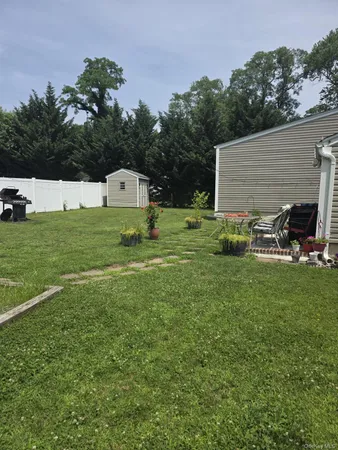 a backyard of a house with table and chairs
