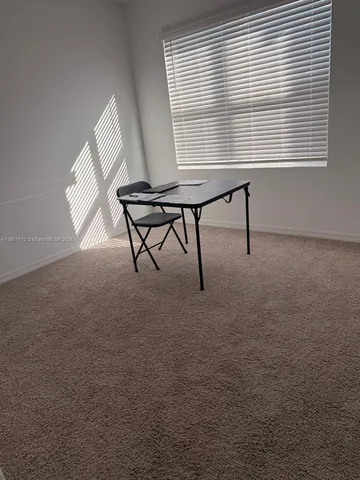 a view of a workspace with a window and sitting area