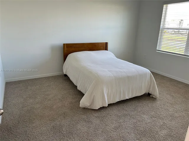a bed sitting in a room next to a window