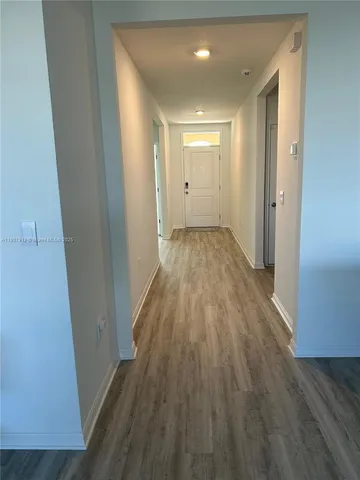 a view of a room with wooden floor