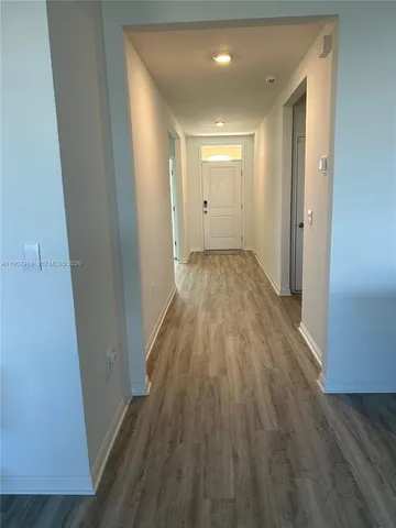 a view of a room with wooden floor