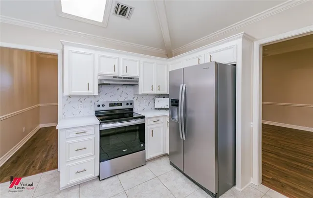 a kitchen with stainless steel appliances granite countertop a sink a stove a table and chairs
