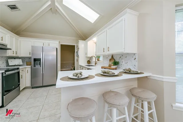 a kitchen with stainless steel appliances a white stove top oven and cabinets