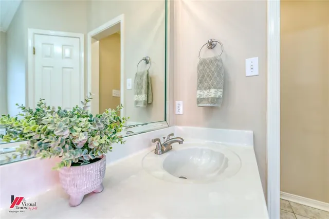a bathroom with a tub sink and mirror