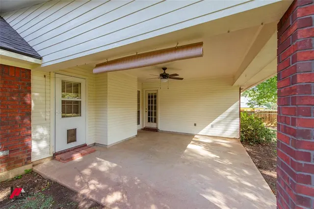 a backyard of a house with table and chairs