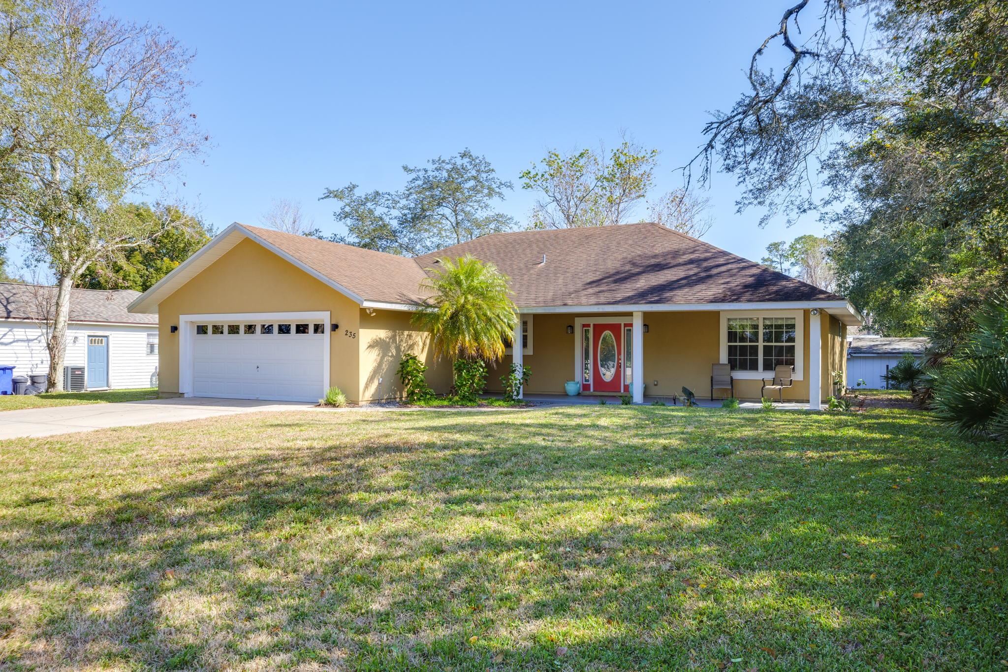 235 Shamrock Road St. Augustine, FL 32086 - Photo 1 of 28 a view of a house with a yard and potted plants