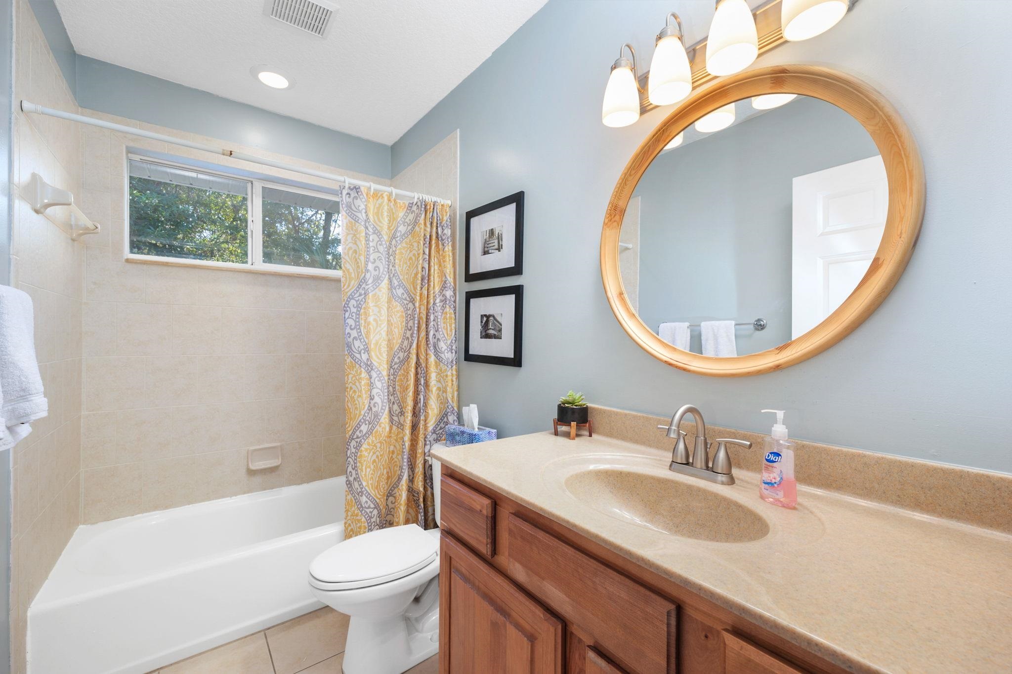 235 Shamrock Road St. Augustine, FL 32086 - Photo 16 of 28 a bathroom with a sink a mirror a toilet and a tub