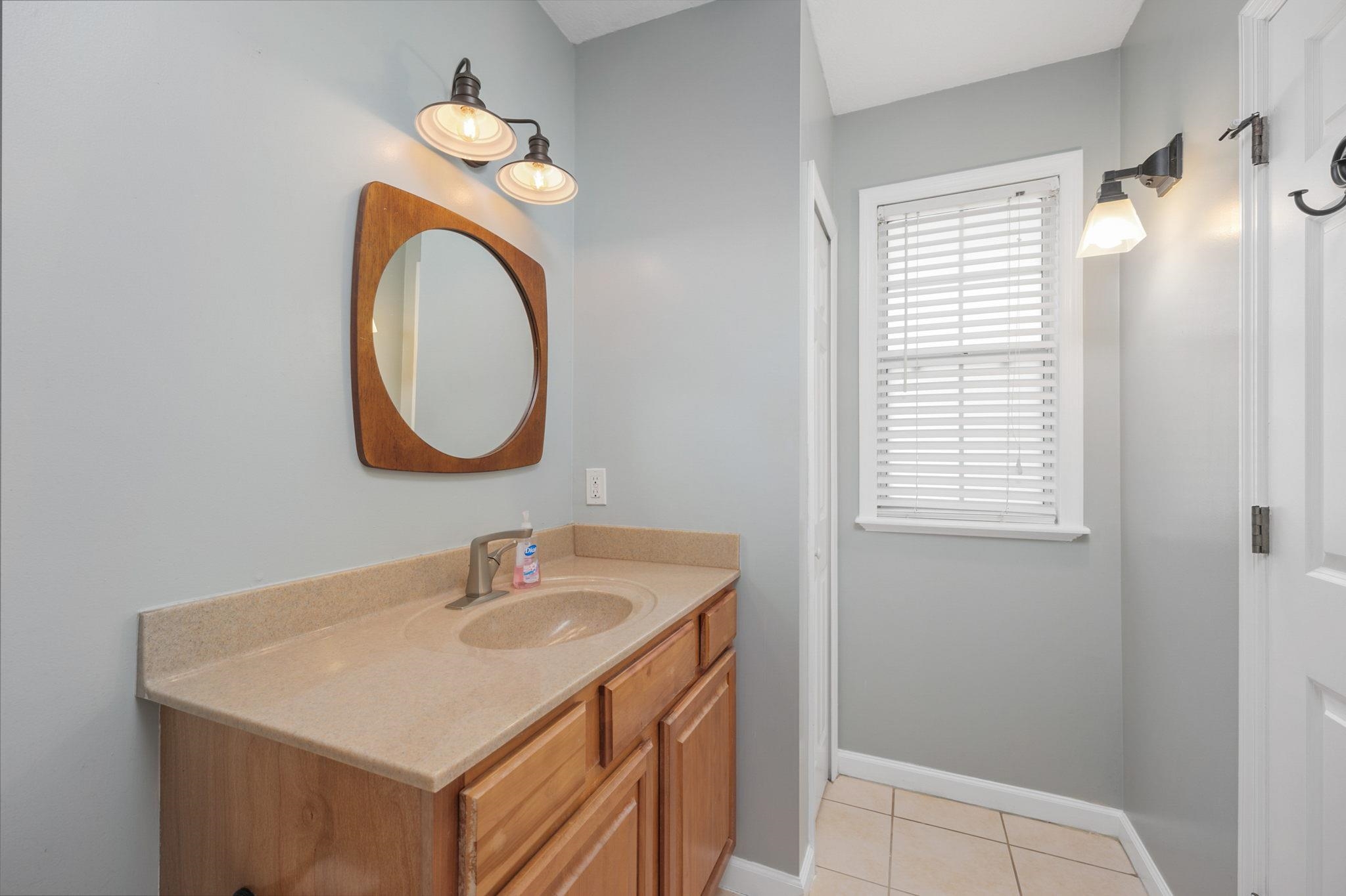 235 Shamrock Road St. Augustine, FL 32086 - Photo 19 of 28 a bathroom with a sink a vanity and a mirror