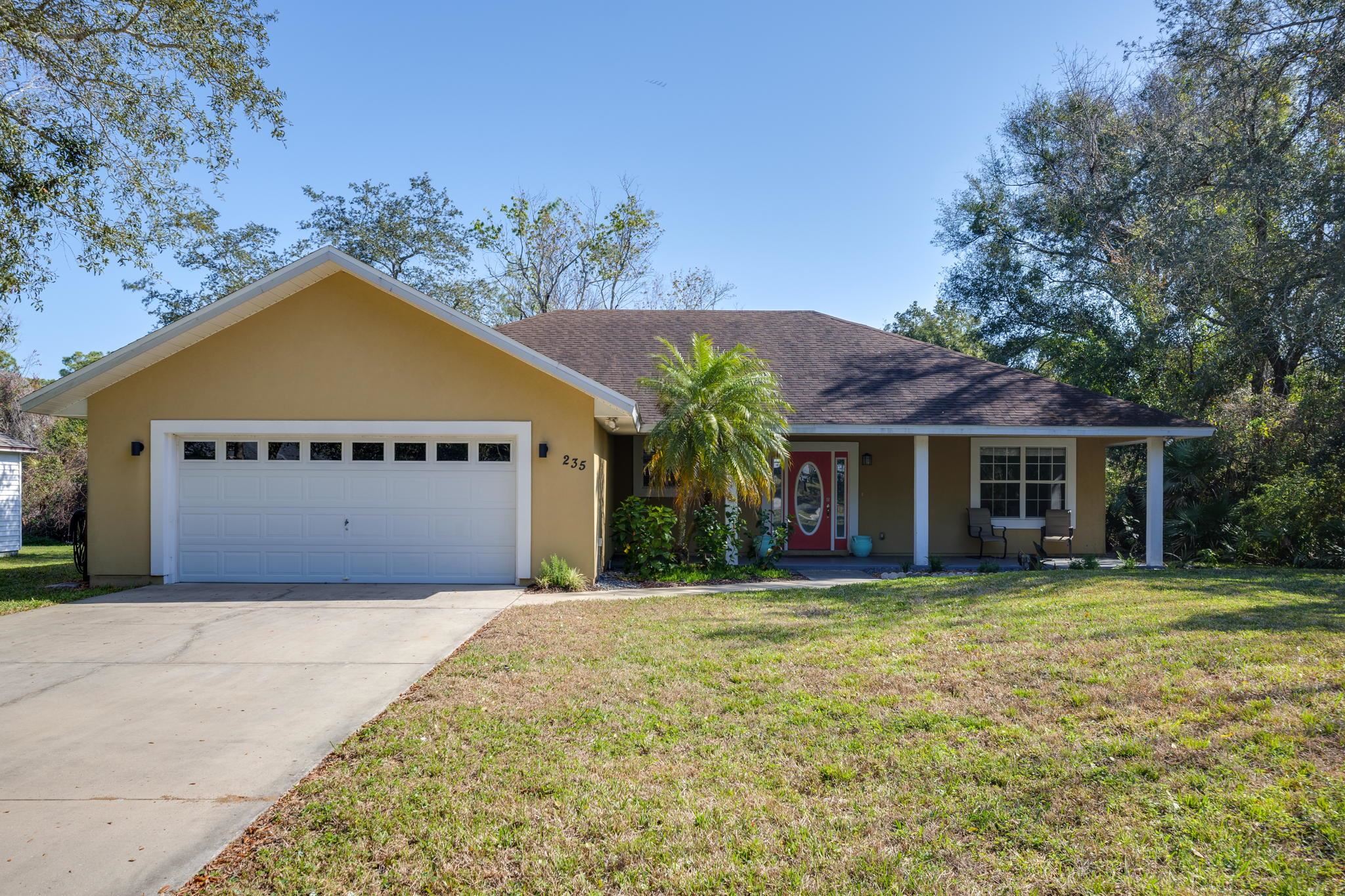 235 Shamrock Road St. Augustine, FL 32086 - Photo 2 of 28 a view of a house with a yard and potted plants