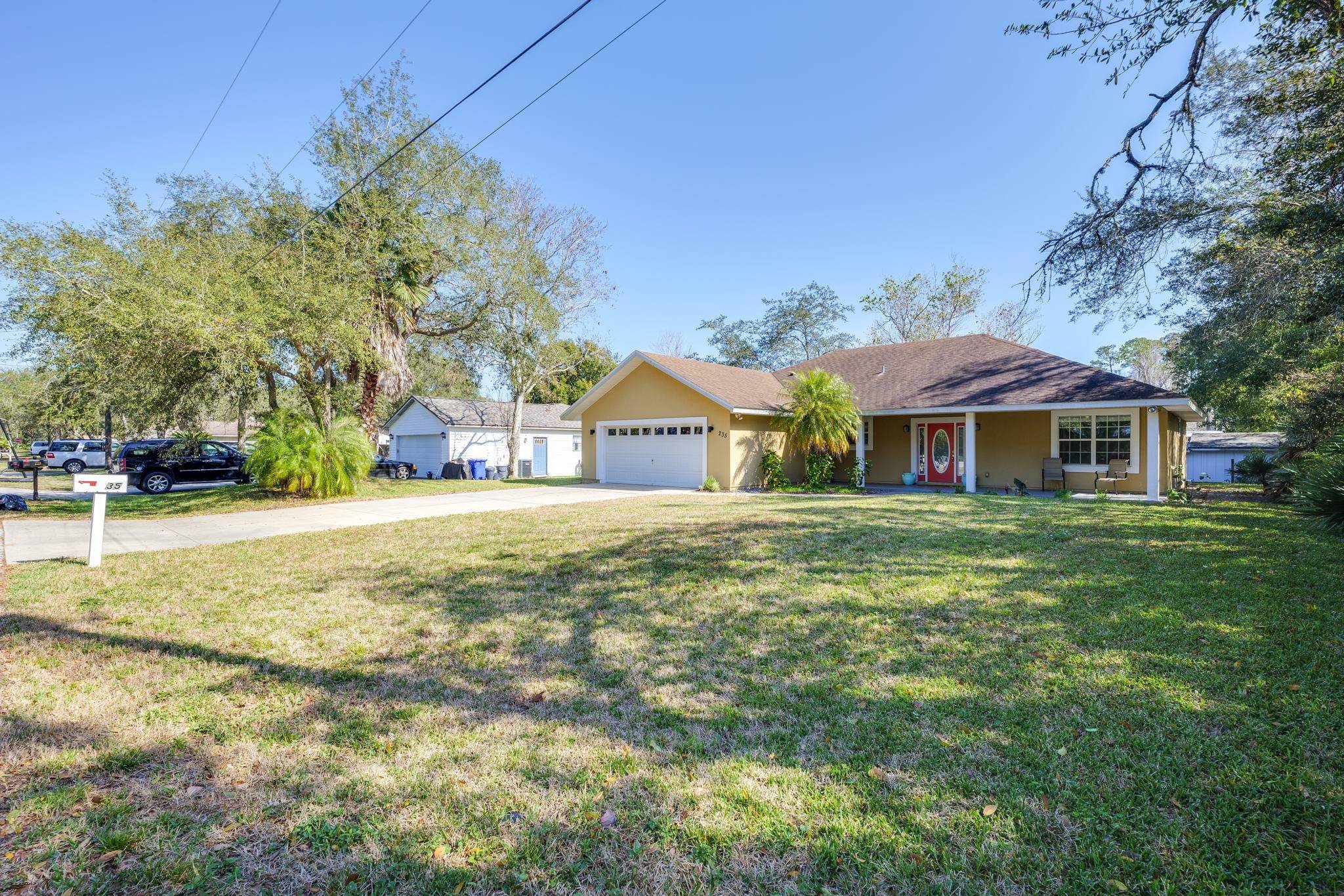 235 Shamrock Road St. Augustine, FL 32086 - Photo 3 of 28 a front view of a house with a yard