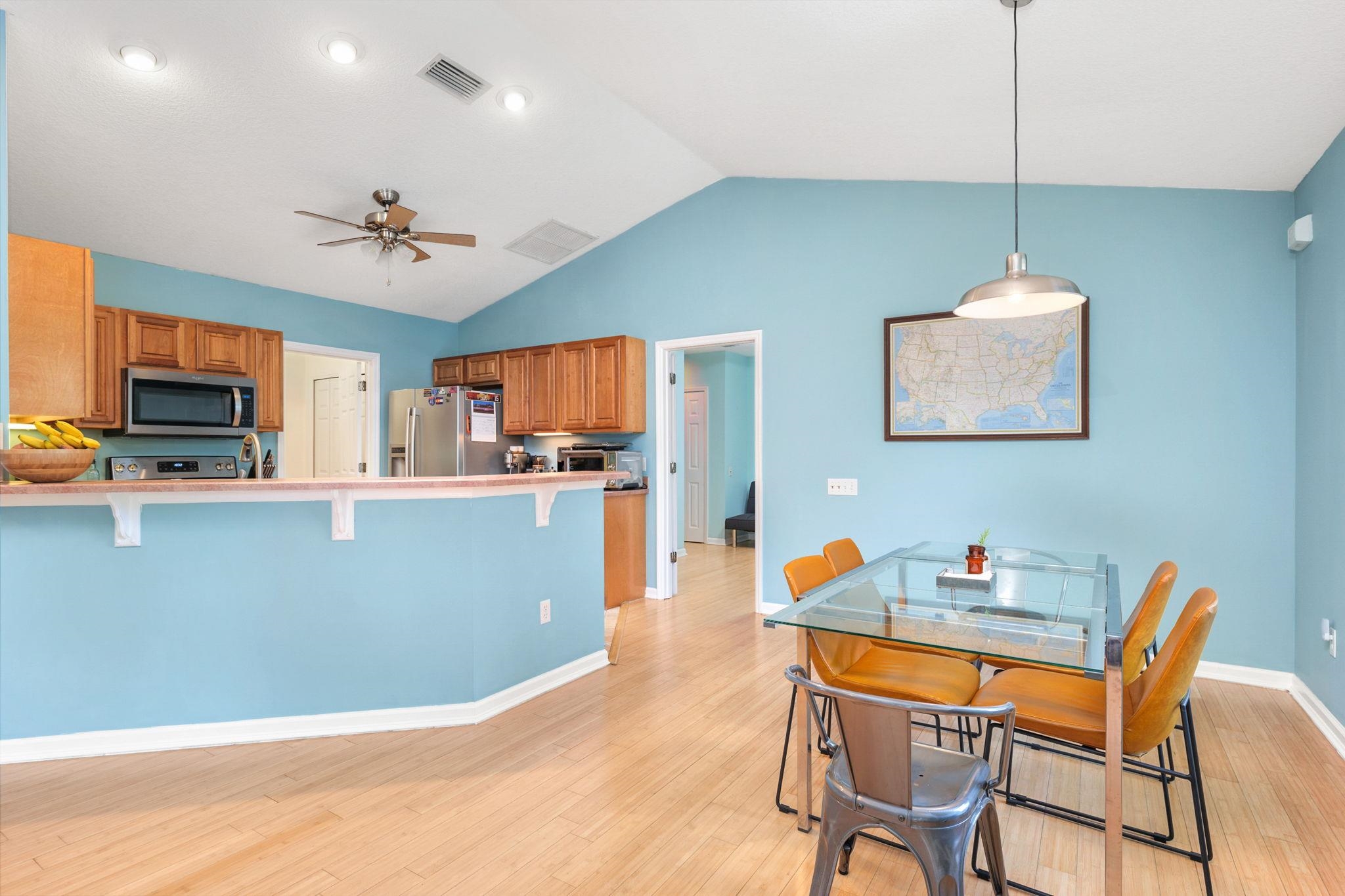 235 Shamrock Road St. Augustine, FL 32086 - Photo 10 of 28 a kitchen with stainless steel appliances granite countertop a dining table chairs refrigerator and microwave