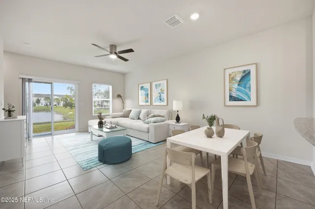 a living room with furniture a flat screen tv and a dining table