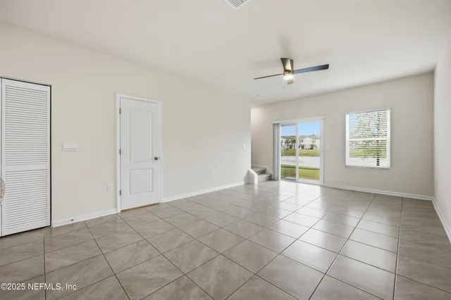 an empty room with windows and closet
