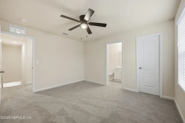a view of an empty room with a fan