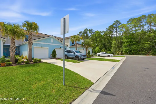 a view of a house with a backyard and a tree