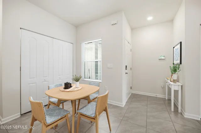 a view of a dining room with furniture and a window