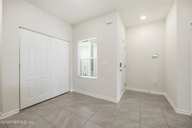 an empty room with windows and closet