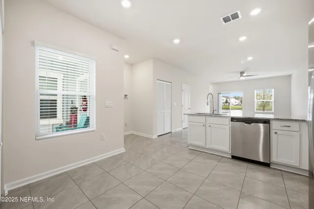 a kitchen with white cabinets and white appliances