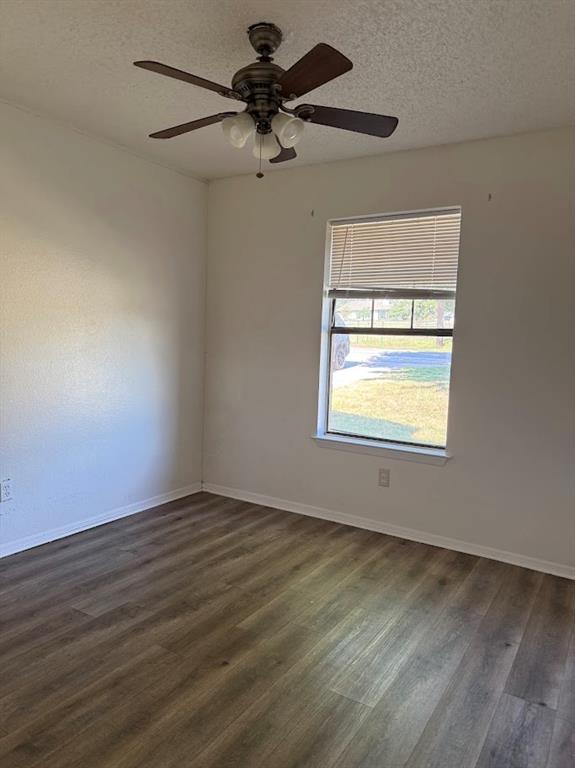 11204 Liberty School Road Pelican Bay, TX 76020 - Photo 17 of 23 an empty room with wooden floor chandelier fan and windows