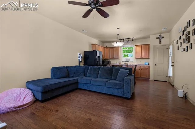 a kitchen with a table chairs refrigerator and cabinets
