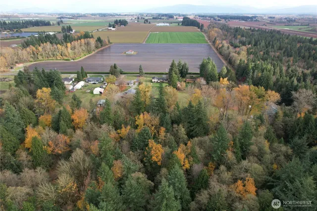 an aerial view of residential houses with outdoor space and river