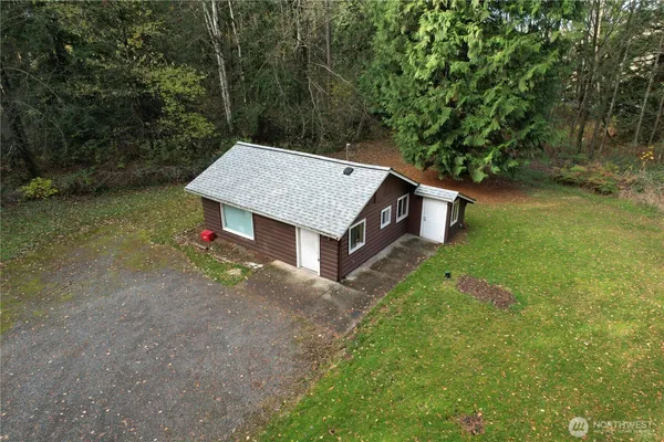 a house with green field in front of it