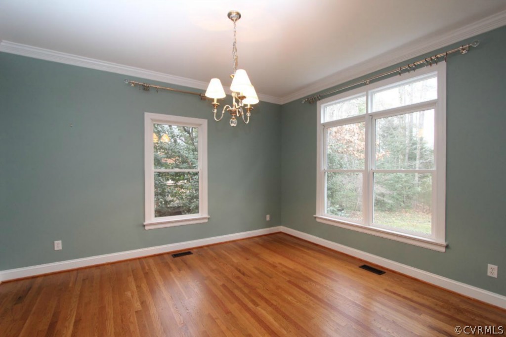 10224 Sioux Road Richmond, VA 23235 - Photo 5 of 24 a view of an empty room with wooden floor and a window