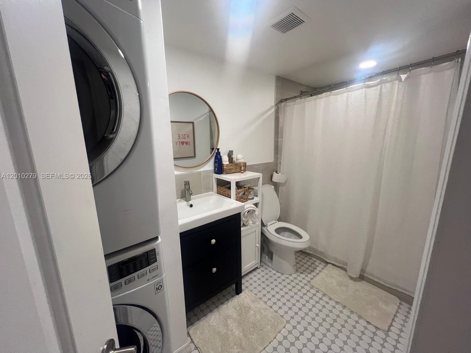 3113 Southwest 14th Street, Unit A Miami, FL 33145 - Photo 11 of 12 a bathroom with a toilet sink and mirror