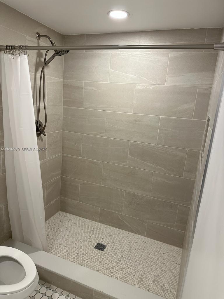 3113 Southwest 14th Street, Unit A Miami, FL 33145 - Photo 6 of 12 a bathroom with a shower and a toilet