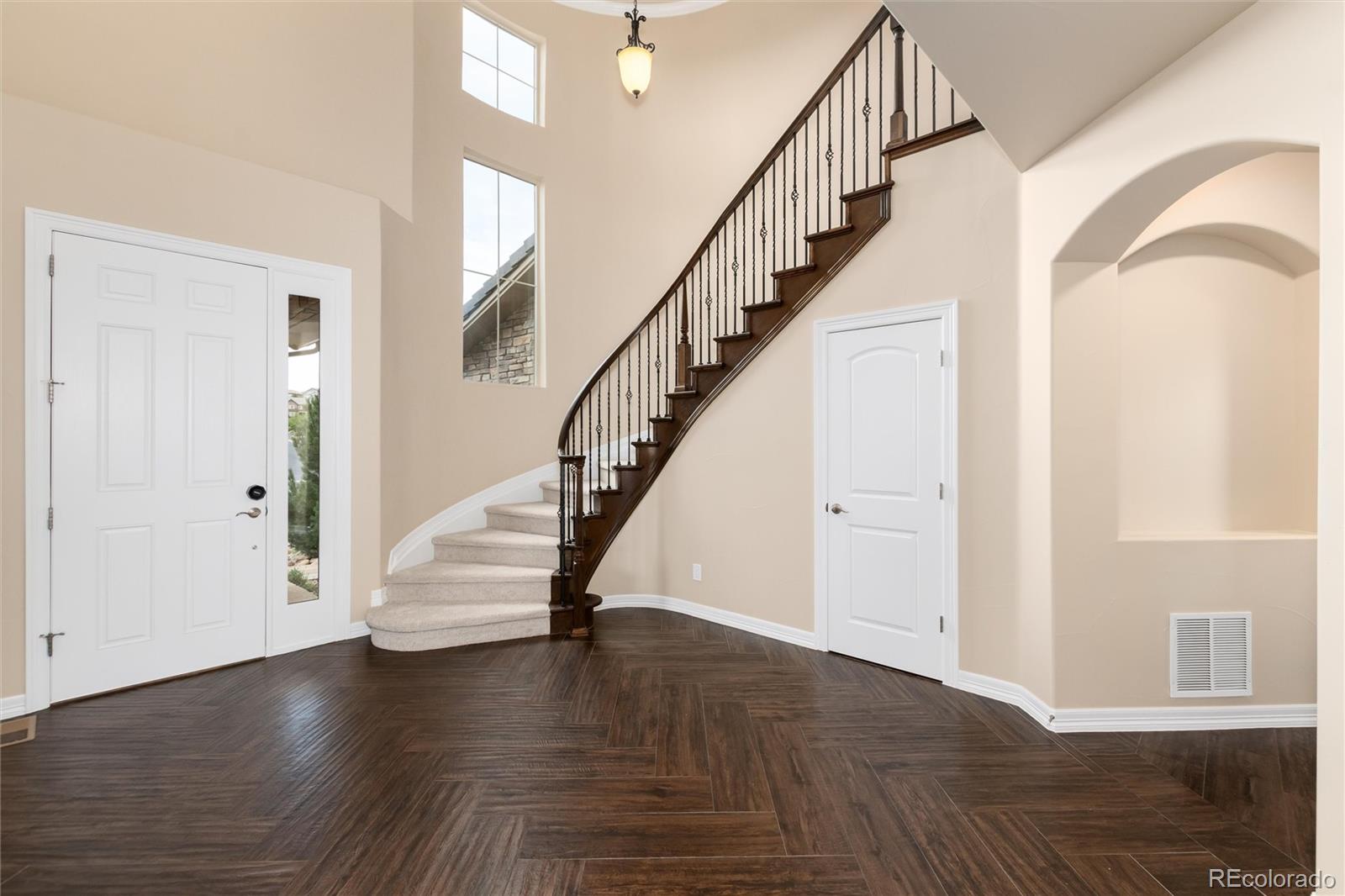 10703 Braesheather Court Highlands Ranch, CO 80126 - Photo 14 of 48 a view of entryway with wooden floor and stairs