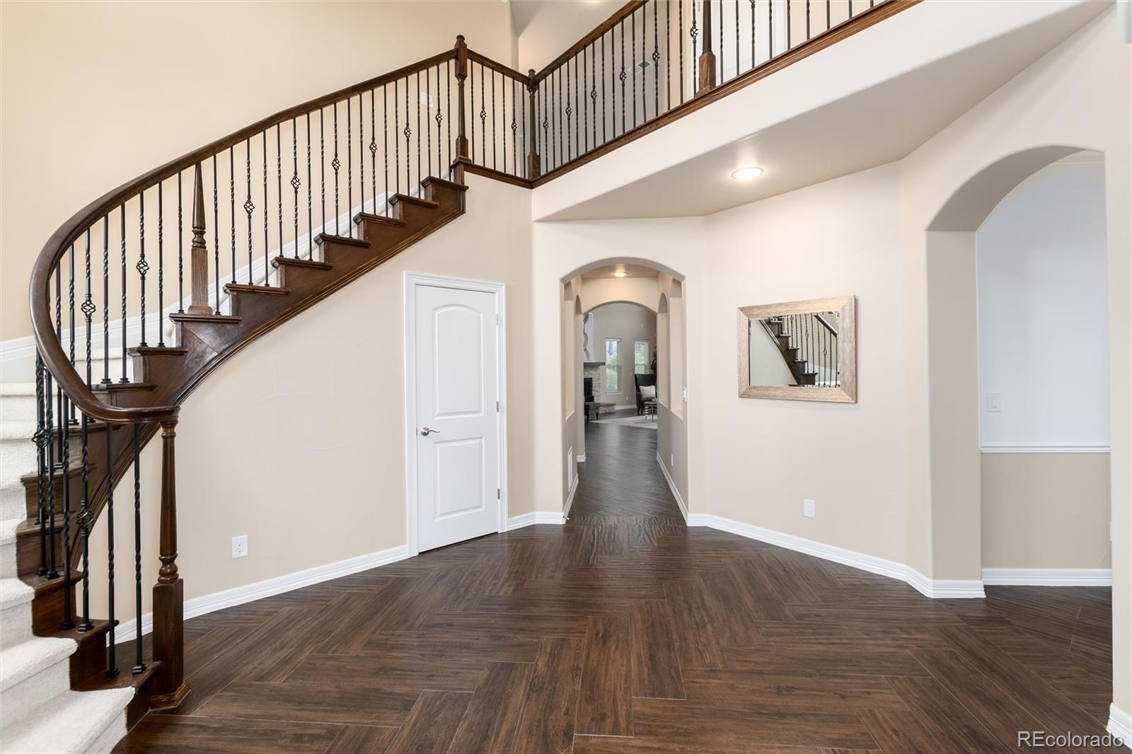 10703 Braesheather Court Highlands Ranch, CO 80126 - Photo 15 of 48 a view of staircase with wooden floor and a rug