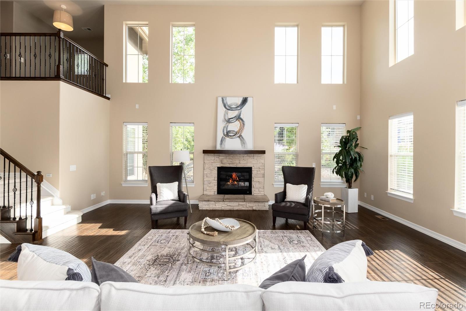10703 Braesheather Court Highlands Ranch, CO 80126 - Photo 17 of 48 a living room with furniture and a fireplace