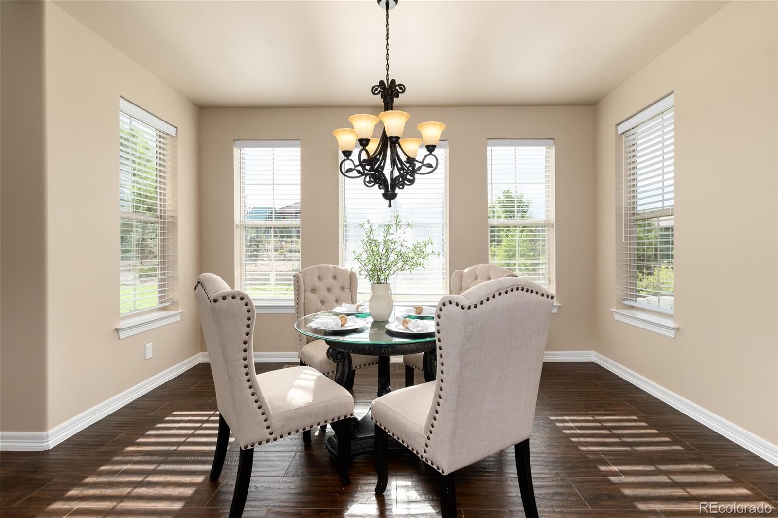 10703 Braesheather Court Highlands Ranch, CO 80126 - Photo 25 of 48 a dining room with furniture wooden floor and a chandelier