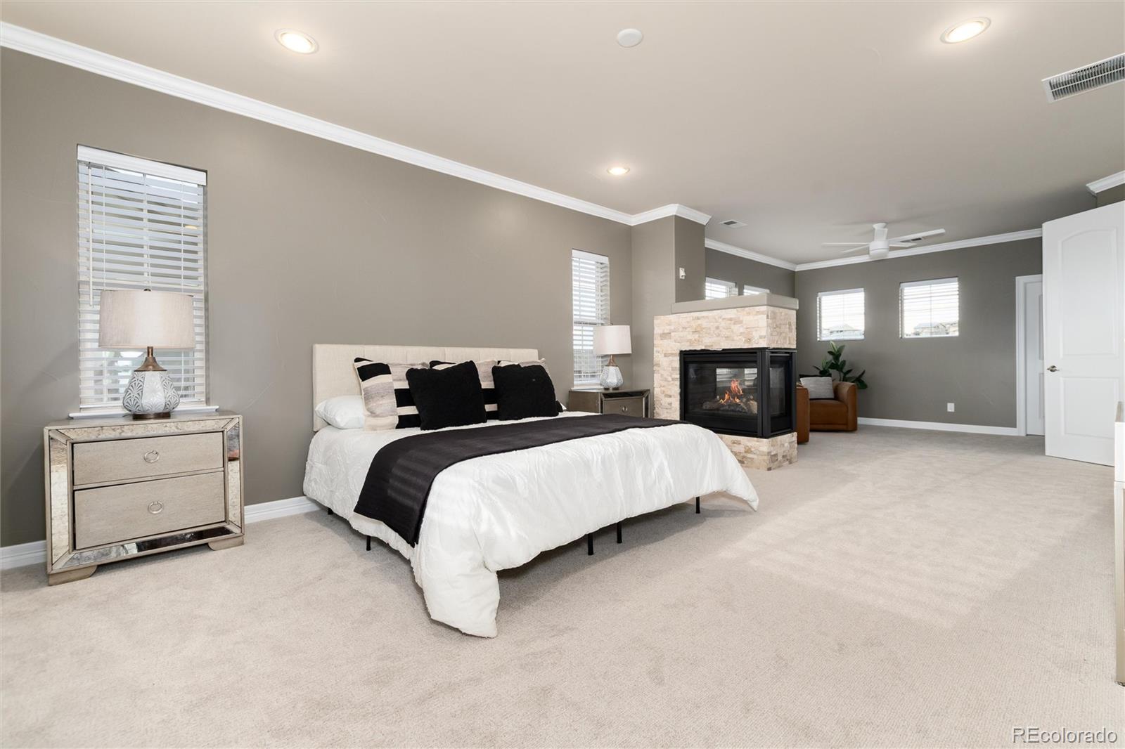 10703 Braesheather Court Highlands Ranch, CO 80126 - Photo 30 of 48 a spacious bedroom with a bed and a dresser