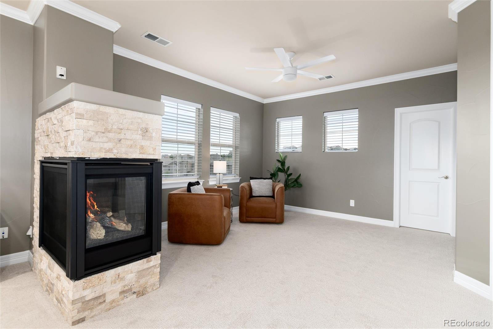 10703 Braesheather Court Highlands Ranch, CO 80126 - Photo 32 of 48 a living room with furniture and a fireplace