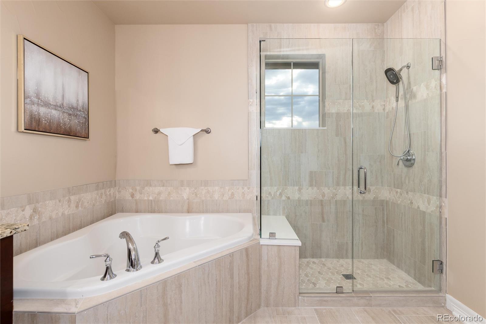 10703 Braesheather Court Highlands Ranch, CO 80126 - Photo 34 of 48 a white bath tub sitting next to a shower